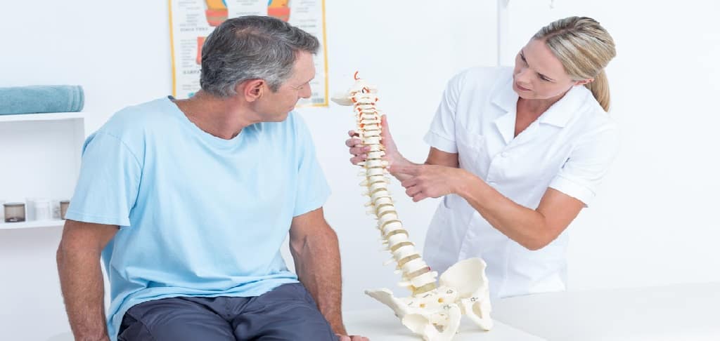 nurse showing bone example to the patient